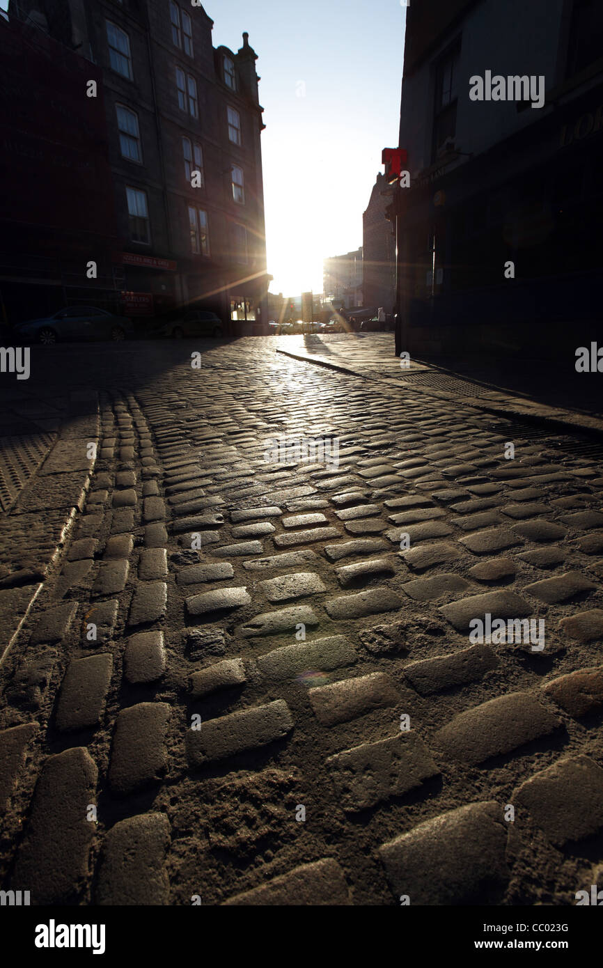 Old cobbles making up the road in the Merchant Quarter of Aberdeen city centre, Scotland, UK Stock Photo
