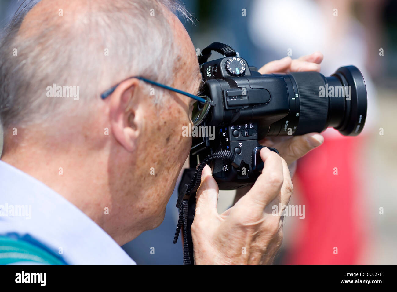 Old man taking a photograph Stock Photo