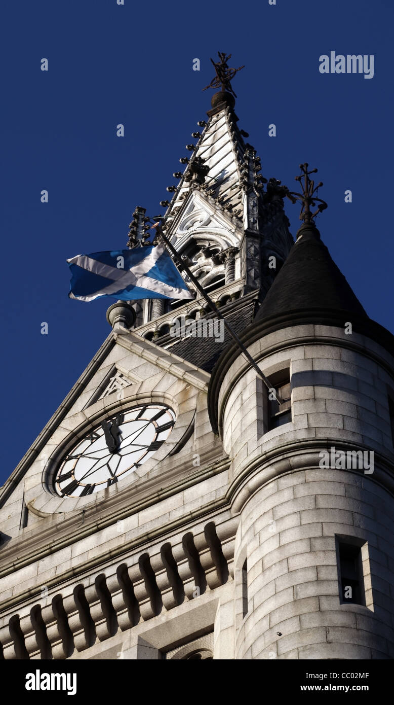 The tower of the Town House in Aberdeen city centre, Scotland, UK, with the Scottish saltire flag flying at noon Stock Photo