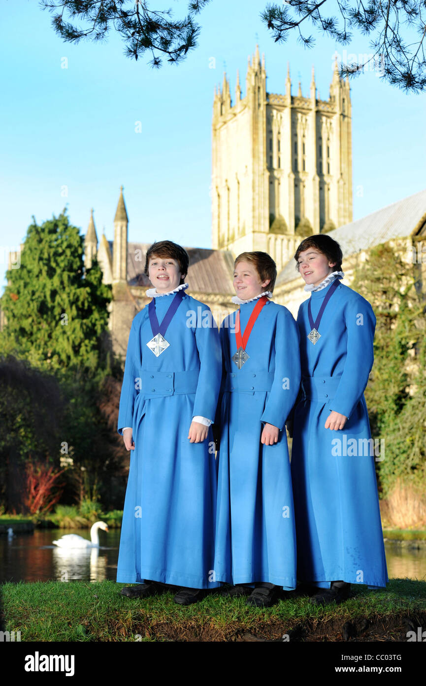 Boy choristers from the Wells Cathedral Choir in Somerset UK take a break from rehearsals by 'The Wells' pond after which the ci Stock Photo