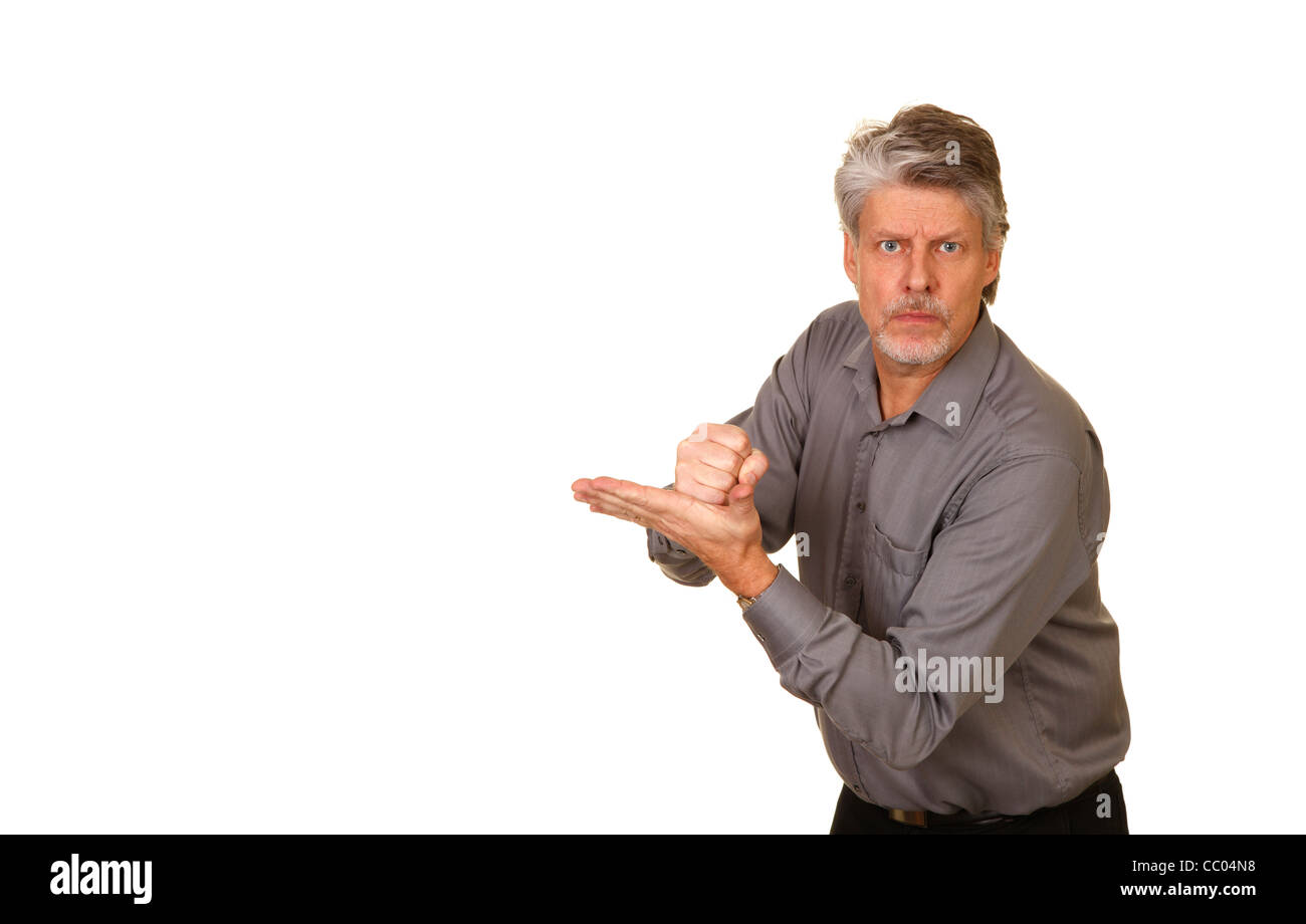 Angry man hitting his palm with his fist Stock Photo