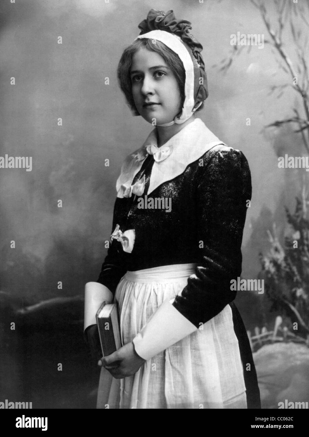 Puritan woman holding book Stock Photo