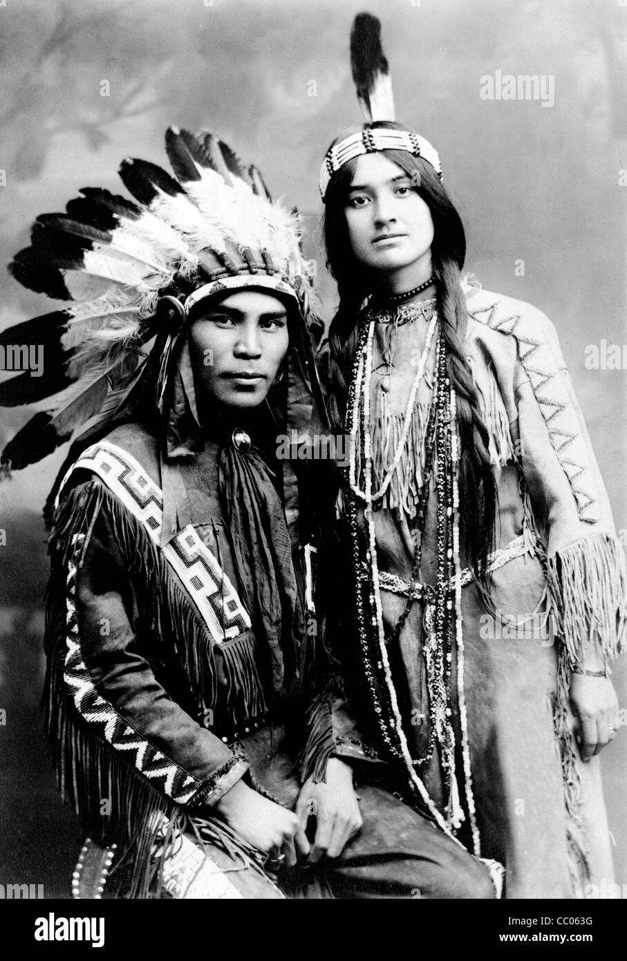 Situwuka & Katkwachsnea, Native man, seated, and woman, standing, facing front, 1912 Stock Photo