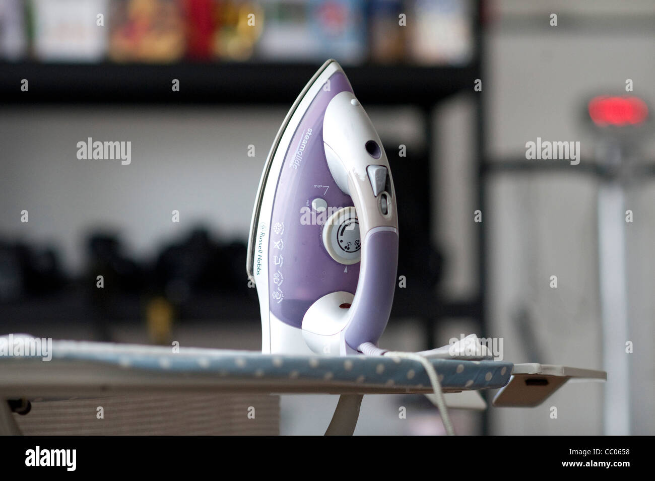 Iron on Ironing board in a home Stock Photo Alamy