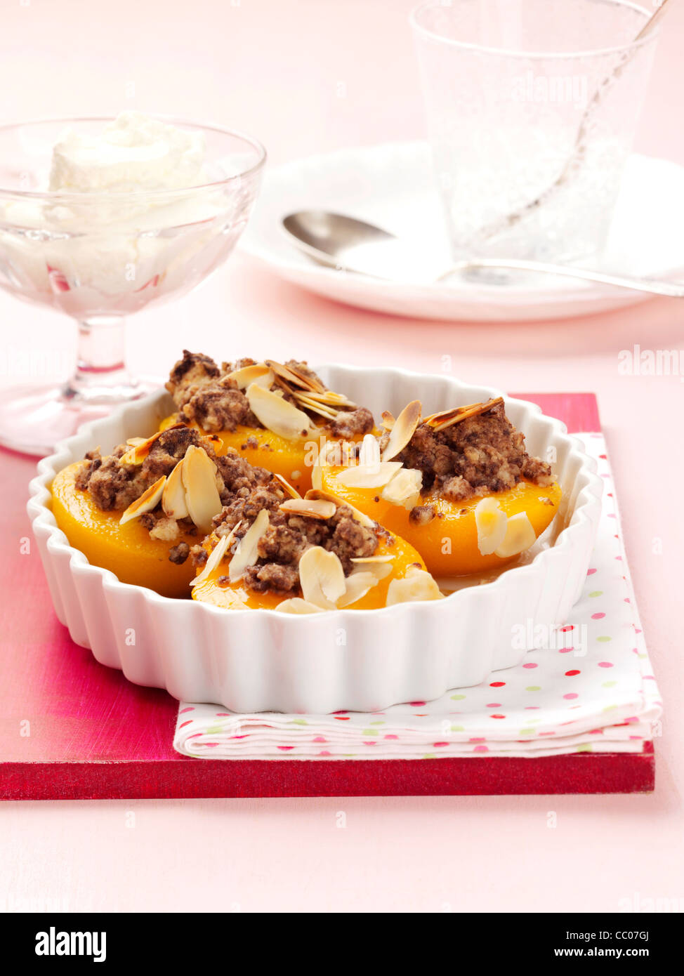 Baked peaches with chocolate crumble topping Stock Photo Alamy