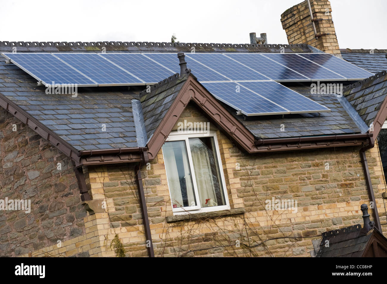 Solar panels fitted to roof of rural detached period house in Clyro Powys Wales UK Stock Photo