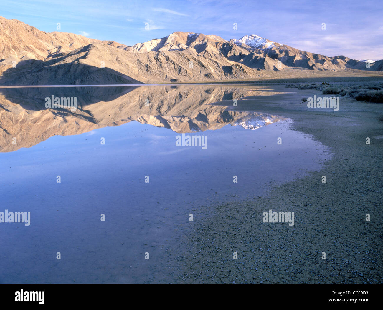 Water from recent rains sits in a usually dry lake bed, Death Valley National Park, California. Stock Photo