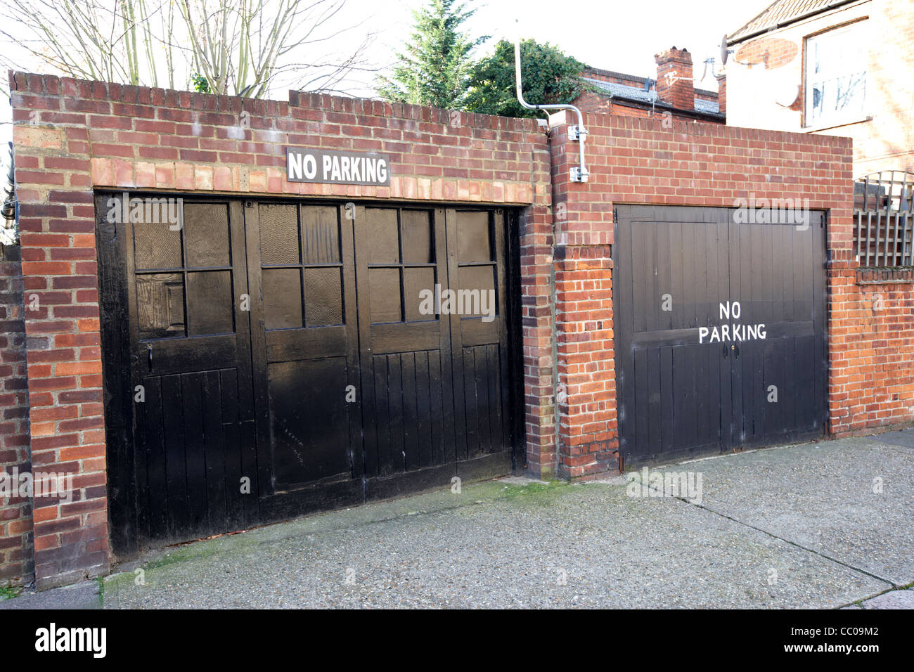 old double garages with no parking signs on a street in north London England UK United kingdom Stock Photo