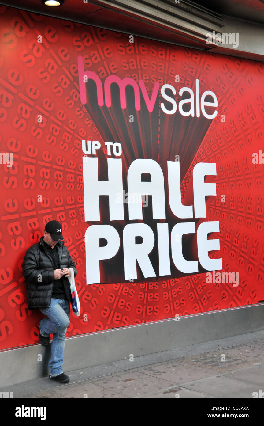 hmv store sale sign man texting january sales london retail sales store sale signs