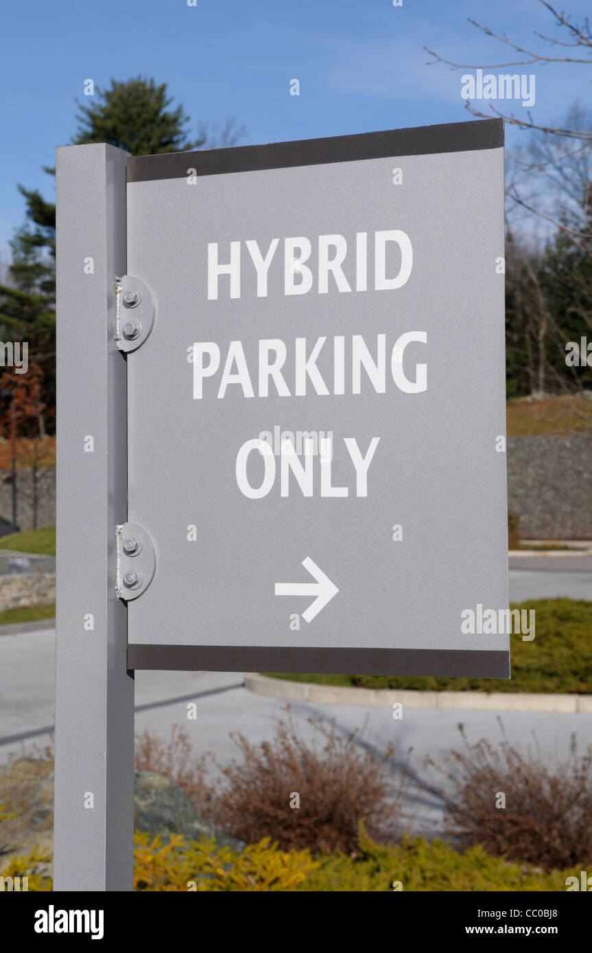 Sign indicating that preferred parking is available for hybrid gas-electric cars at an eco-friendly hotel in Massachusetts. Stock Photo
