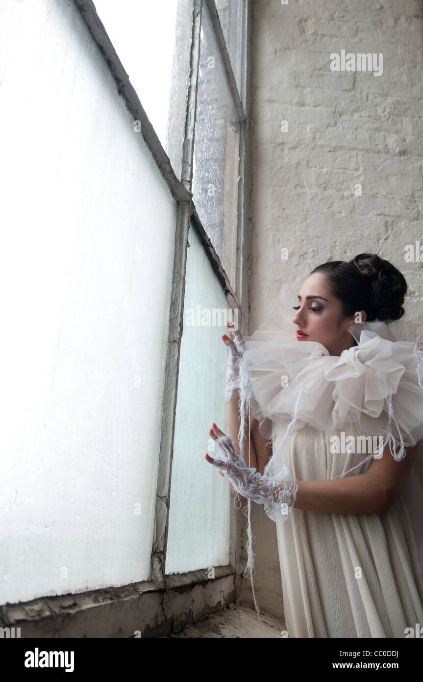 Sad woman looking out of the window Stock Photo - Alamy