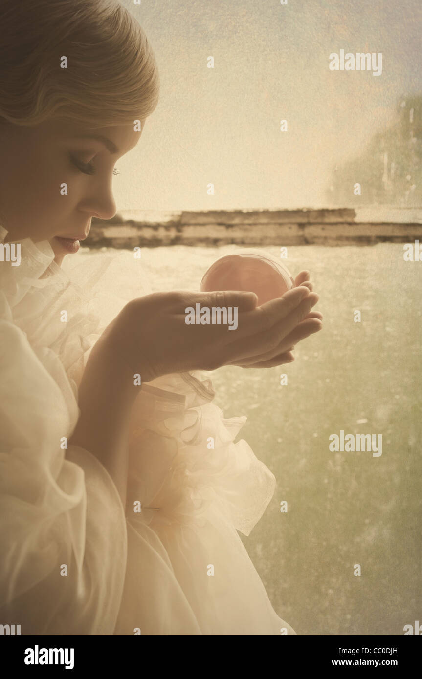 Woman holding a crystal ball Stock Photo - Alamy