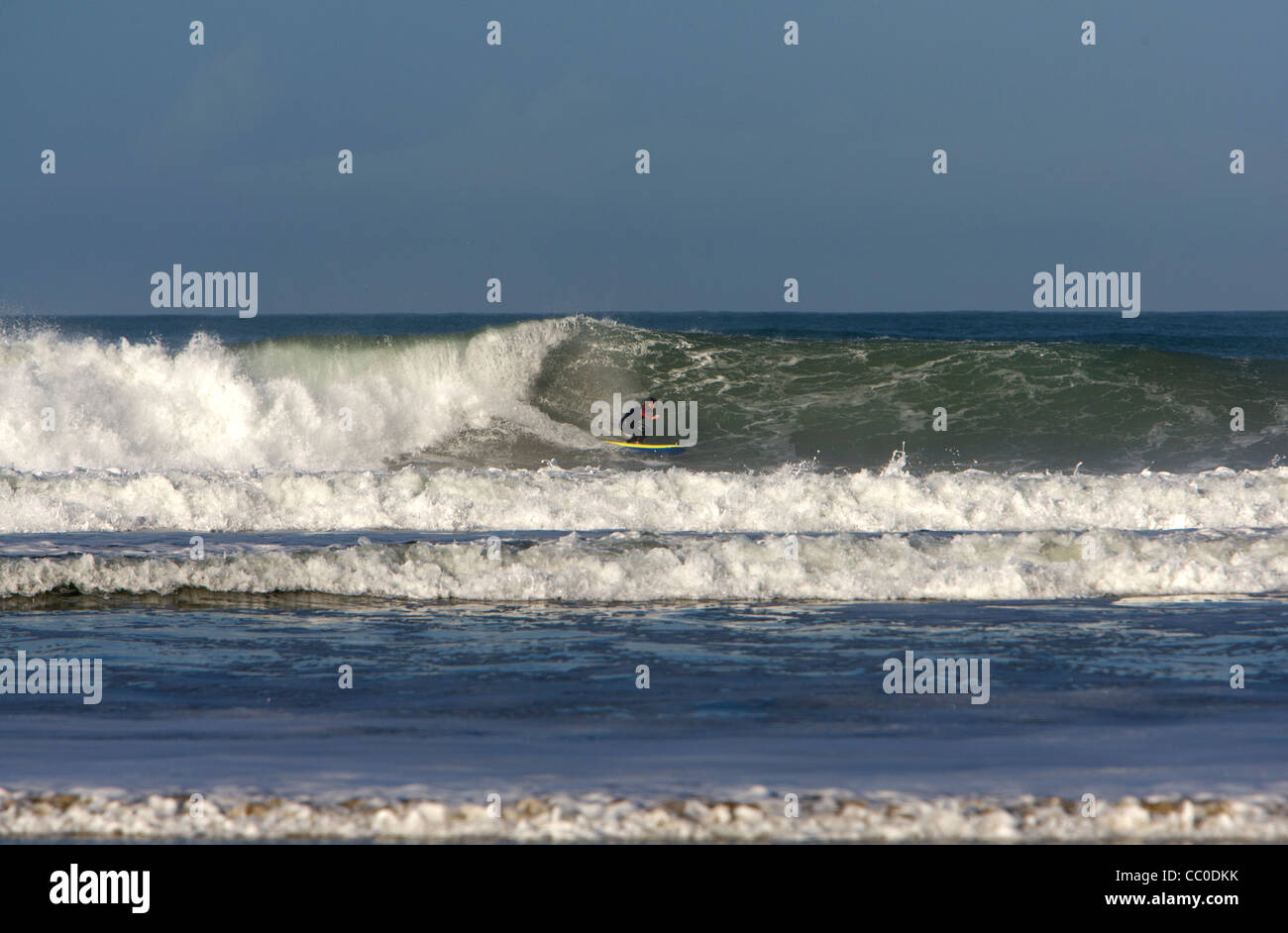 A surfer on a big wave at Porthtowan beach, Cornwall. Stock Photo