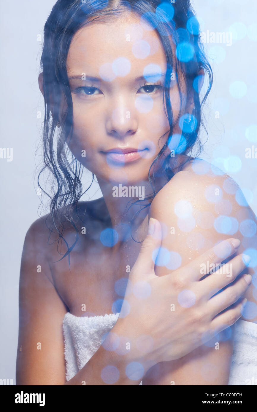 Shower beauty portrait of Asian woman wrapped in towel, with wet hairs