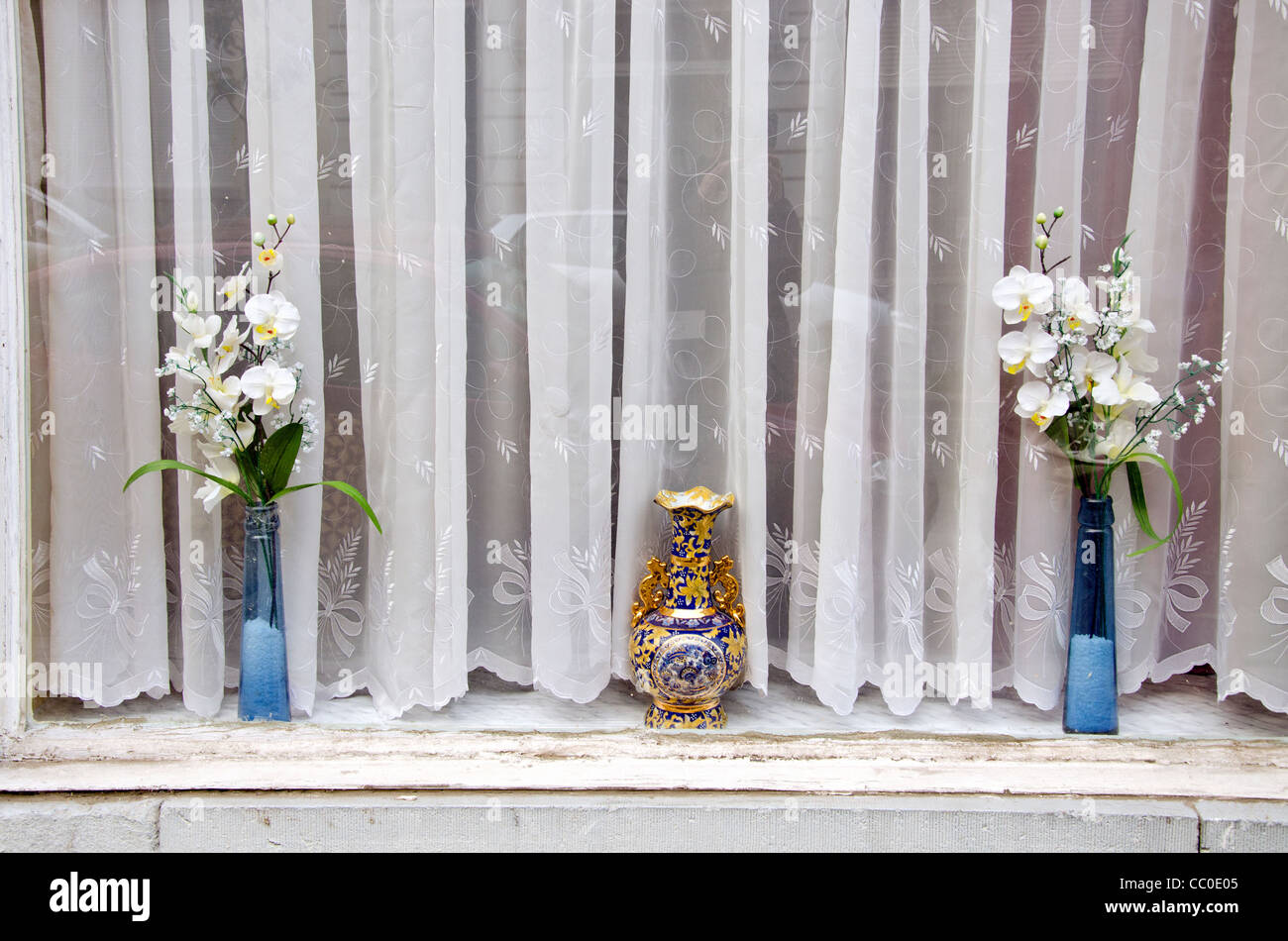 old window in the town with flowers and curtain Stock Photo - Alamy