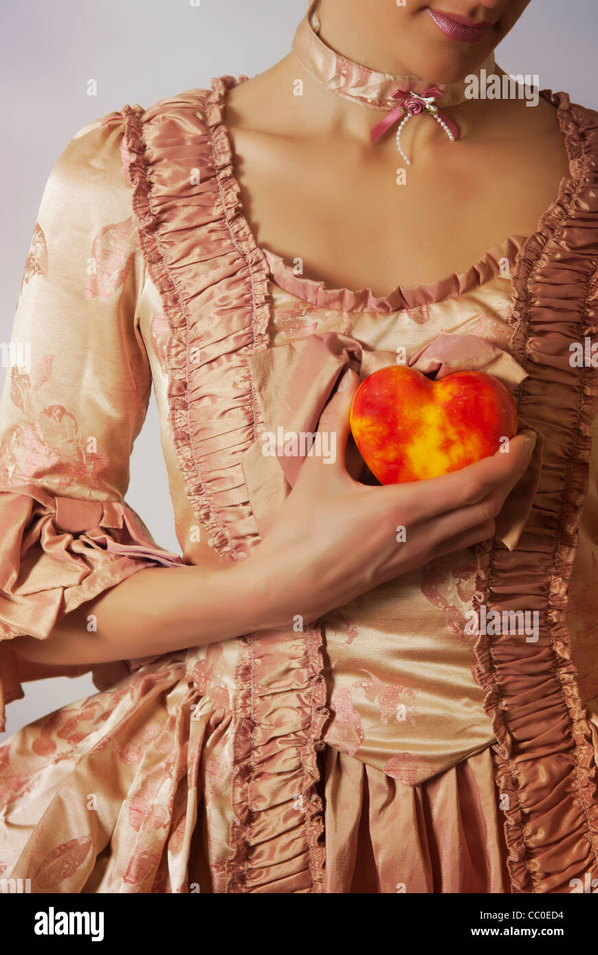 Renaissance woman holding a heart Stock Photo Alamy