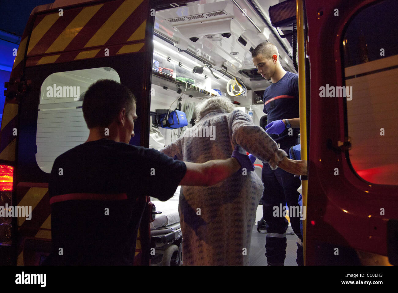 TRANSPORT OF AN OLD WOMAN, WHO FELL ILL IN HER OWN HOME, IN THE FIREFIGHTERS' AMBULANCE, MULHOUSE, HAUT-RHIN (68), FRANCE Stock Photo