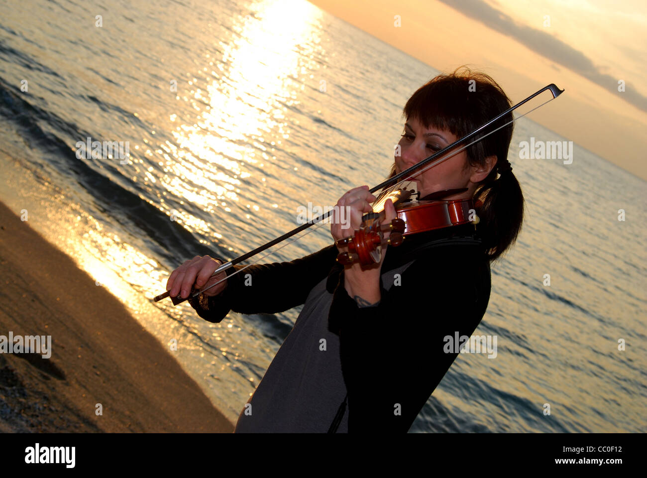 young woman at sea while is playing the violin Stock Photo - Alamy