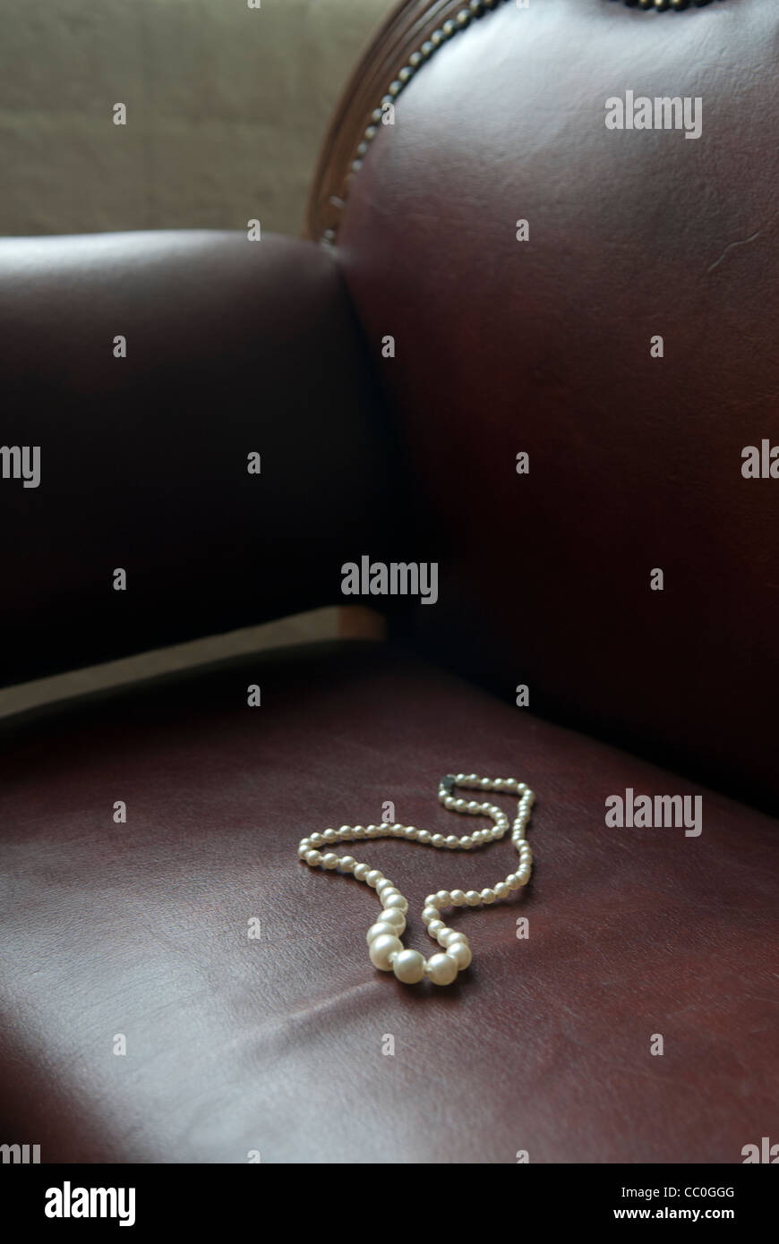 Pearls necklace abandoned on sofa Stock Photo