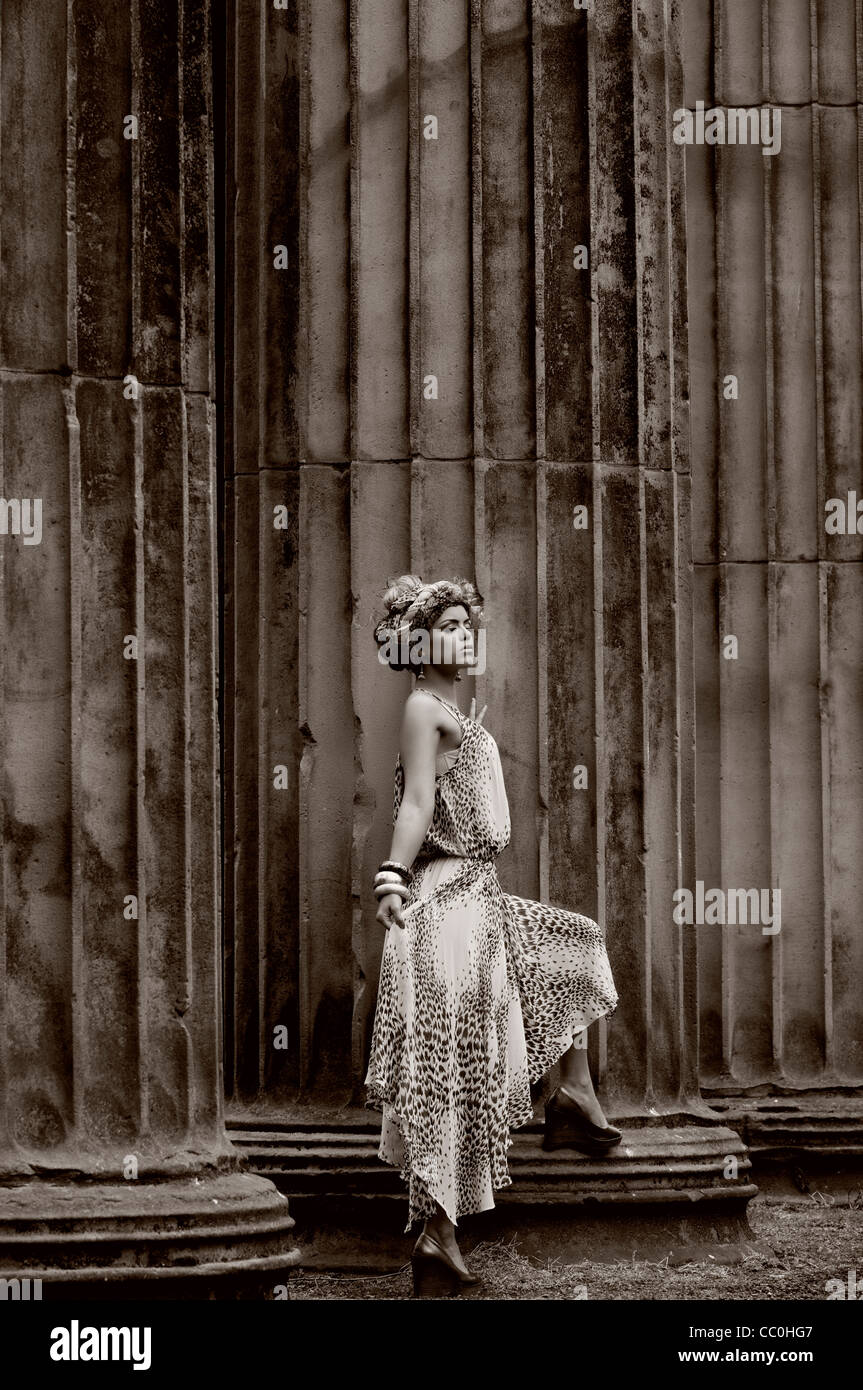 Fashion model standing next to Roman pillars Stock Photo Alamy