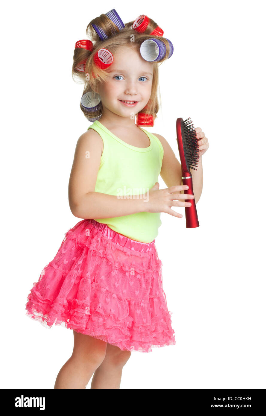 Little girl play big and barber with comb and hair rollers Stock Photo
