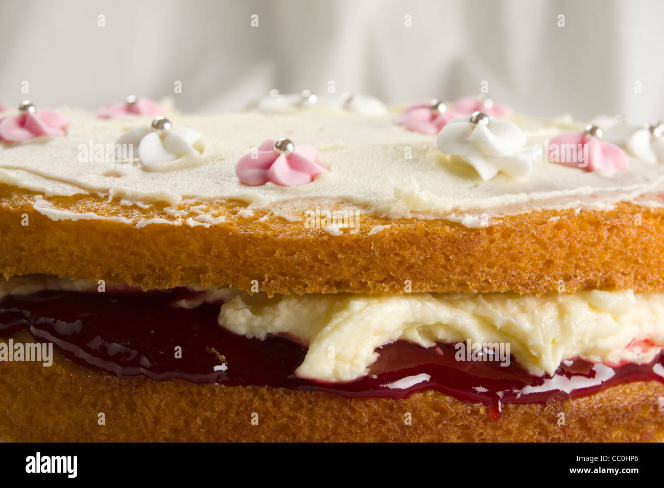 Home baked Victoria sponge cake with buttercream and raspberry jam