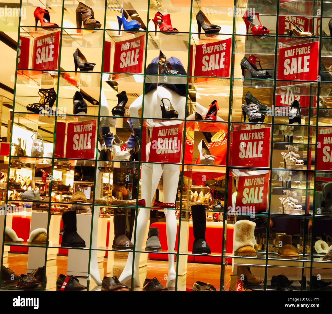 Half price sale sign in shoe shop window in Manchester airport Stock Photo