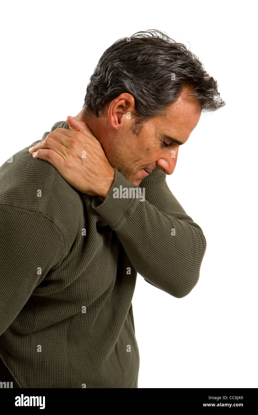 Middle aged man rubs his shoulder to relieve the painful muscles. Stock Photo