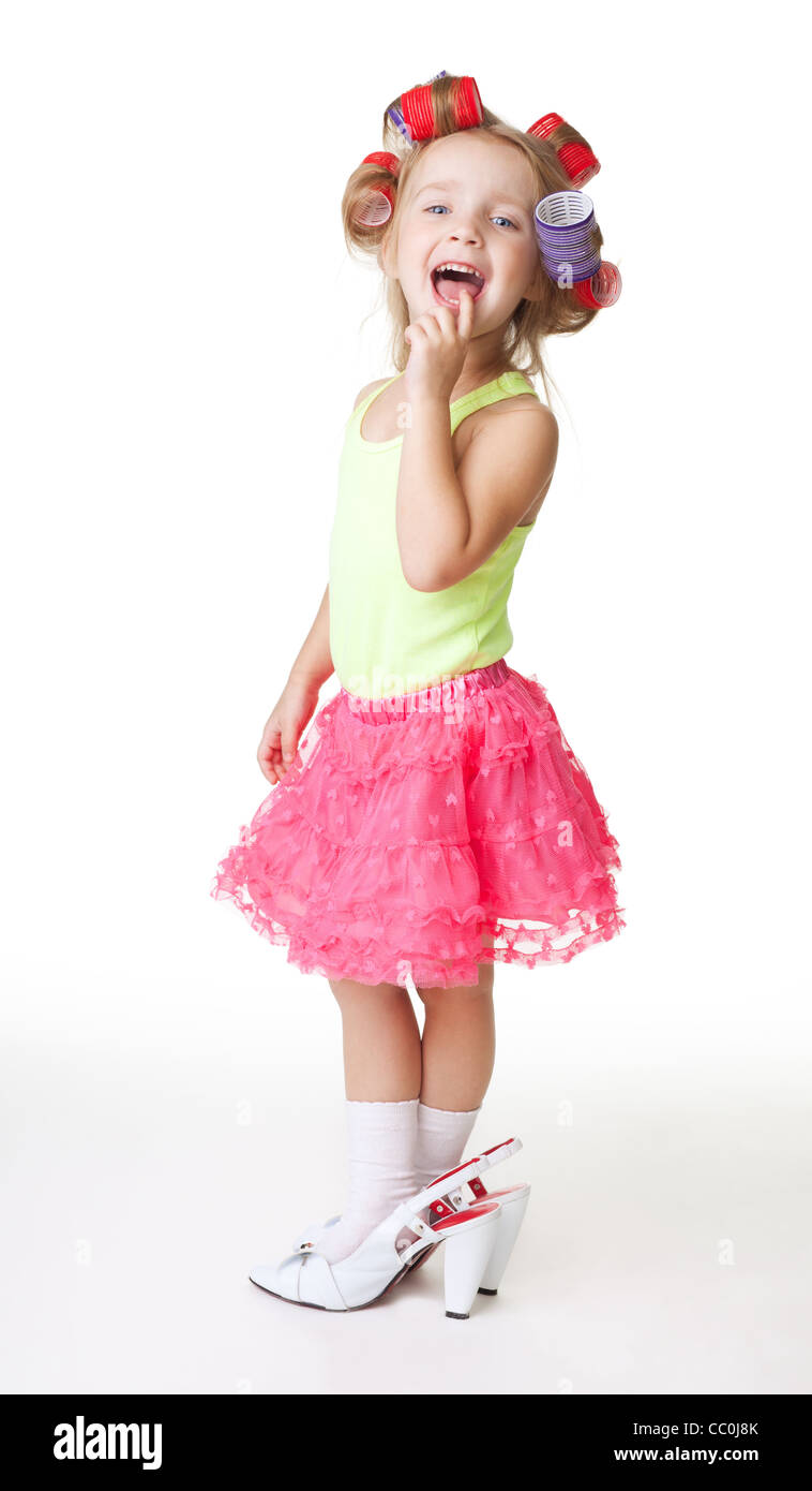 fashion-conscious little girl with mothers rollers and big size shoes Stock Photo