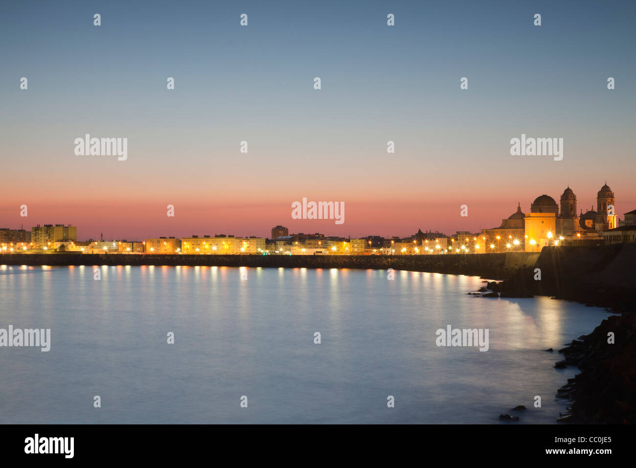 Cadiz harbour and reflections at sunset. Stock Photo