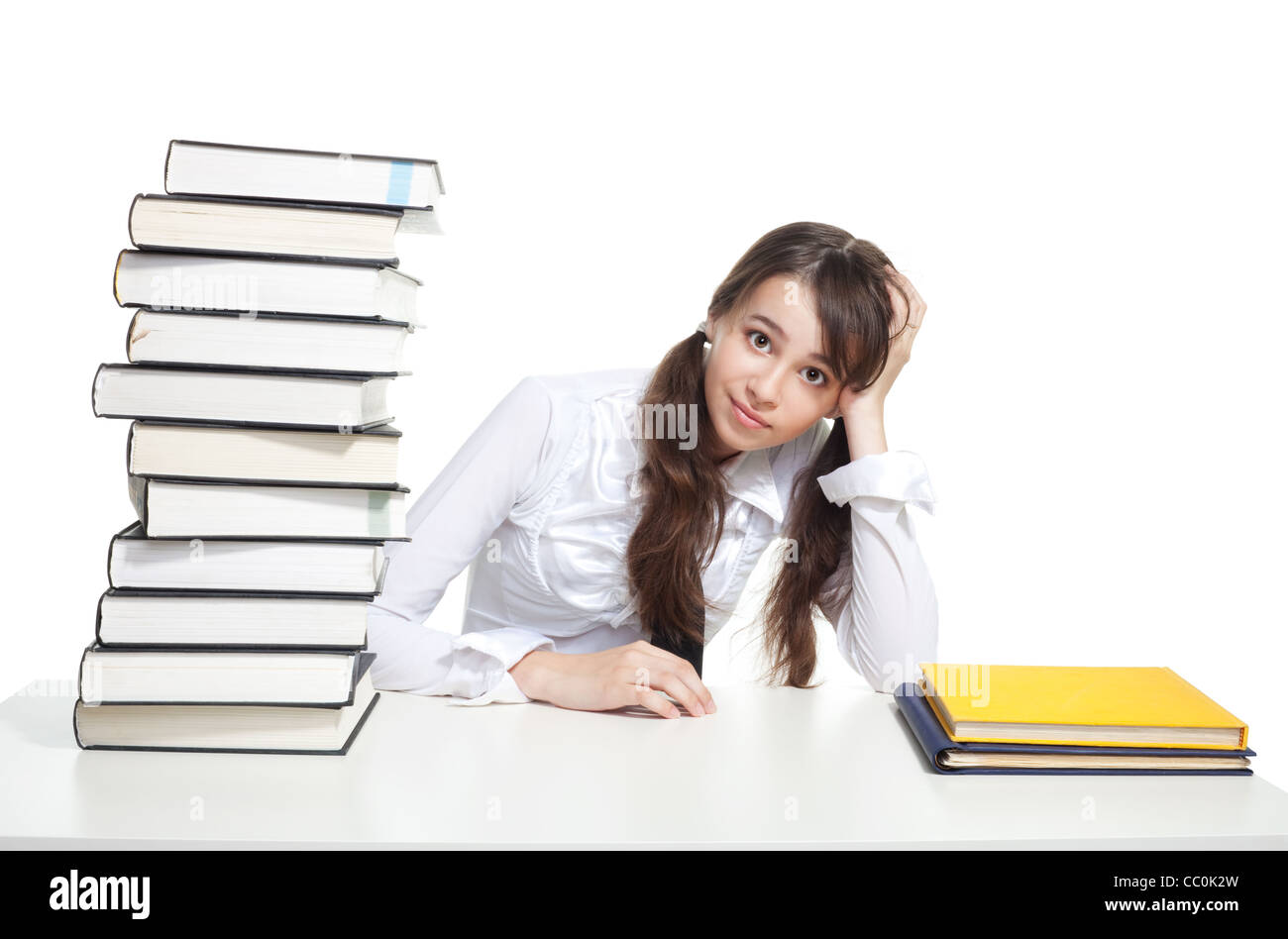 Confused student girl sit with a pile of books Stock Photo - Alamy