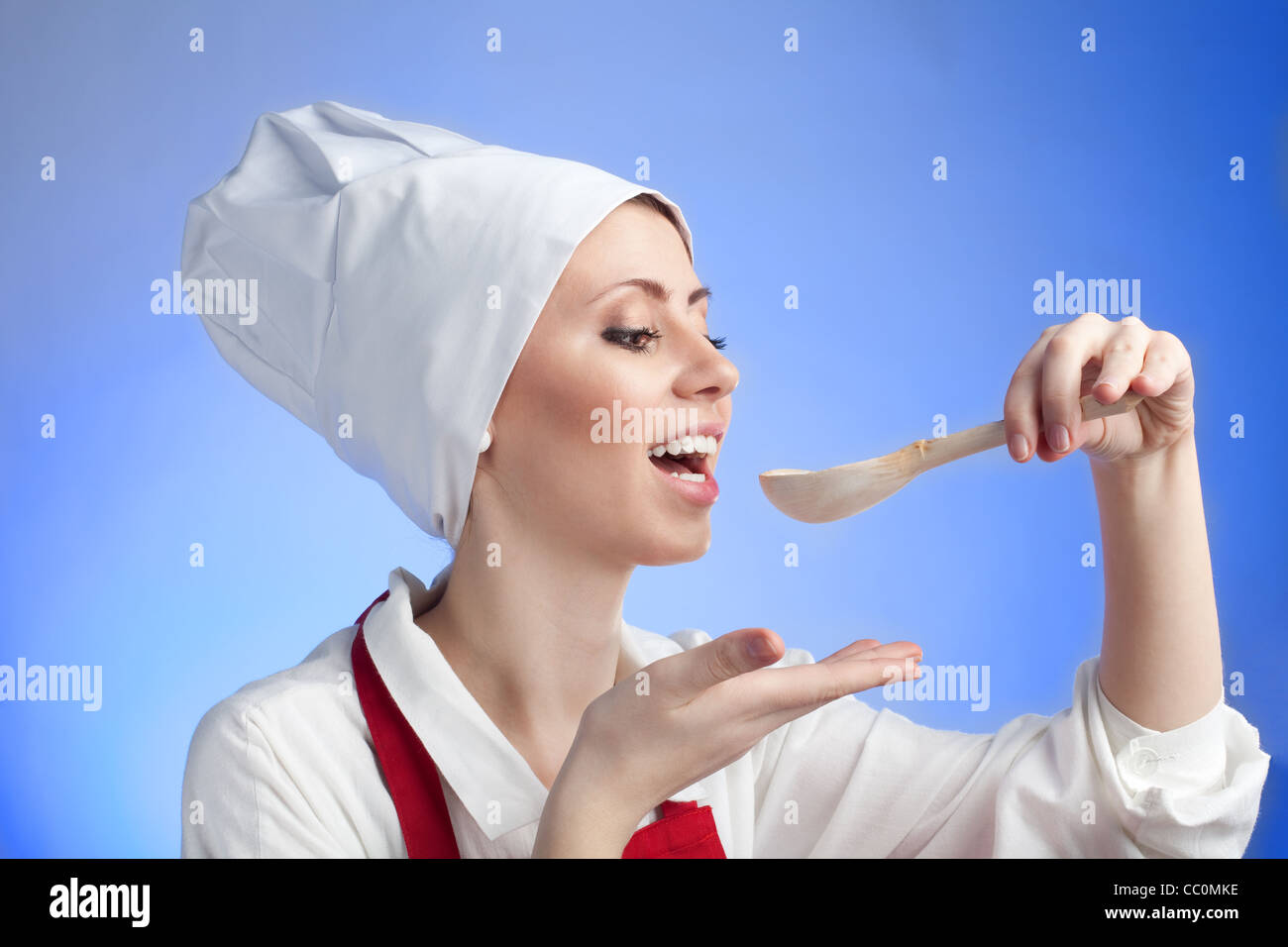 Cooking Use Spoon Happy cook tasting using wood spoon in traditional costume Stock Photo ...