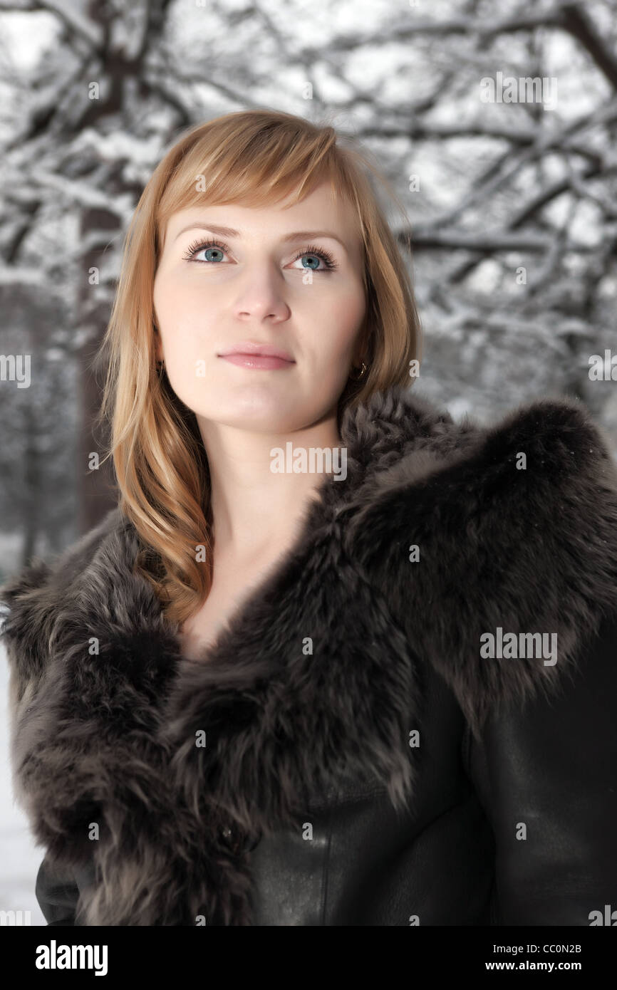 Beautiful young woman in winter fur coat. Winter portrait Stock Photo