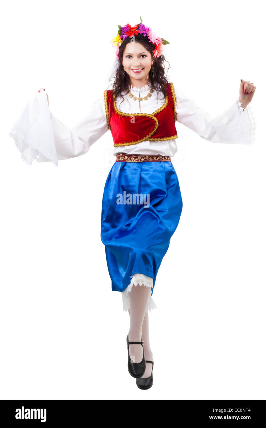 Greek woman squat dancing in traditional costume Stock Photo