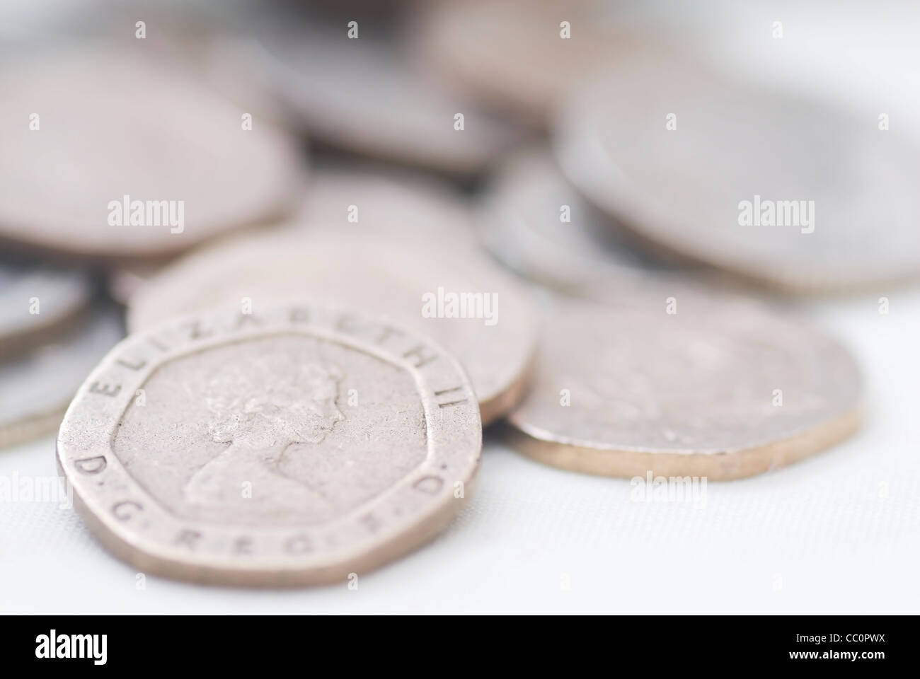 Spilled coins, focus on 20 pence coin. Sterling. Stock Photo