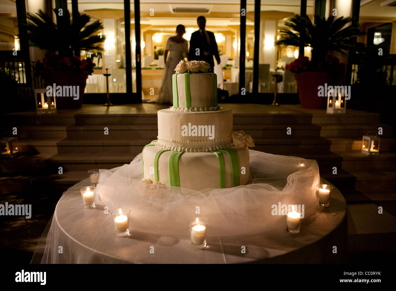 Candle lit wedding cake at reception Stock Photo - Alamy