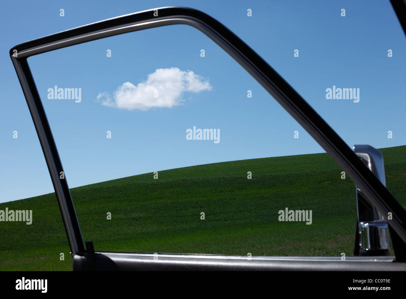 Single Cloud viewed through automobile door Stock Photo