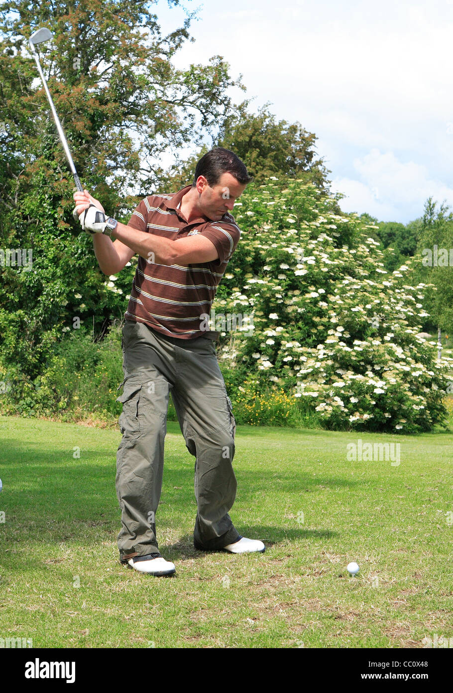 Golfer driving off .Ballinamore golf club. Co. Leitrim. Ireland Stock Photo