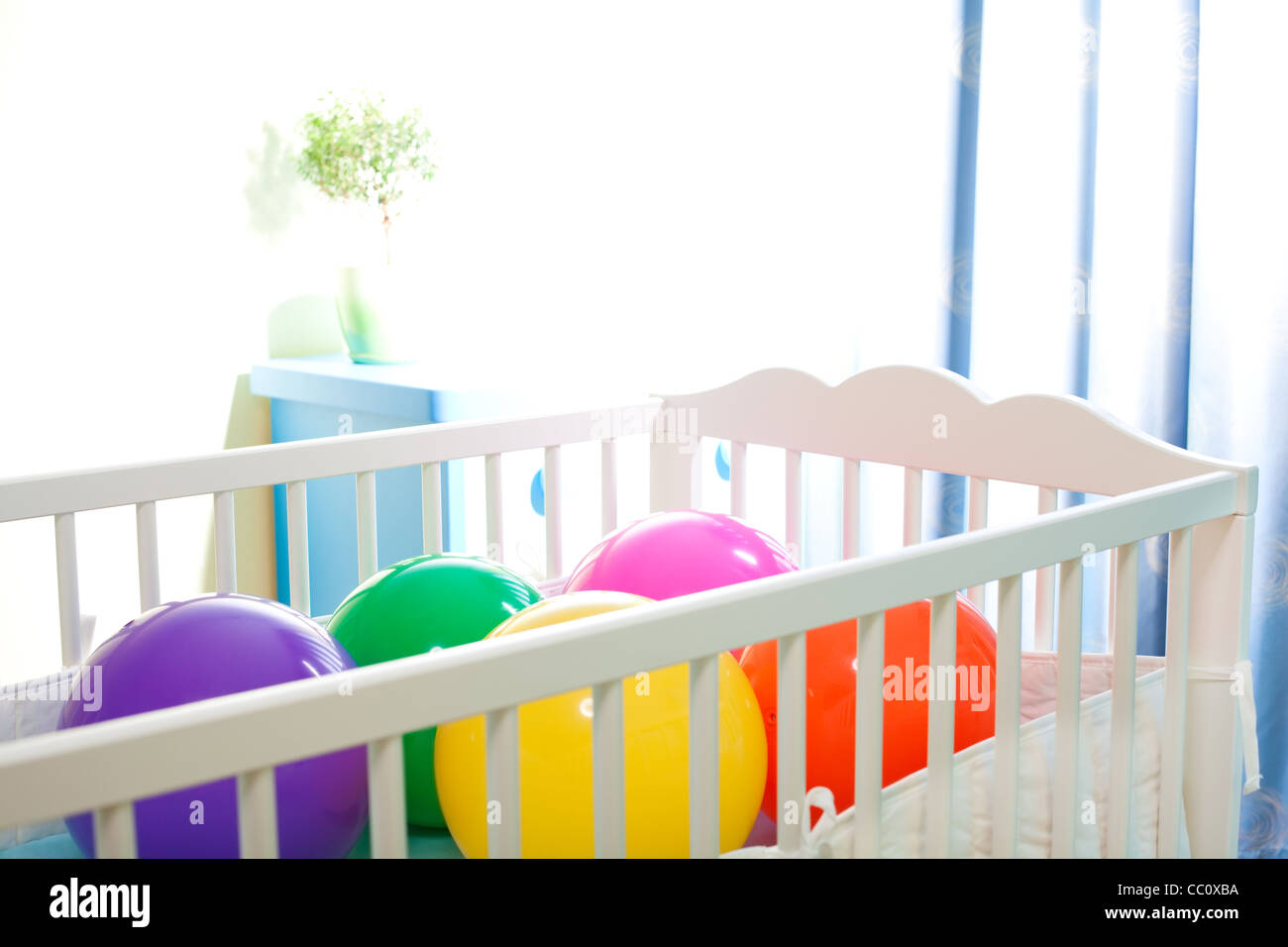 baby cot with colorful balls as concept of great occasion of birth ...