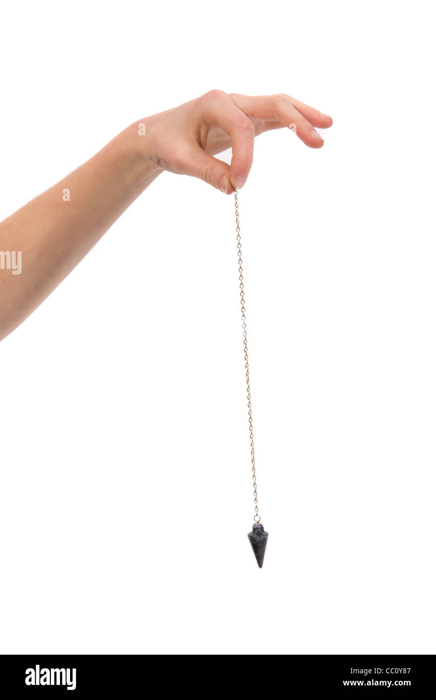 A female hand holding a fortune telling pendant. Stock Photo