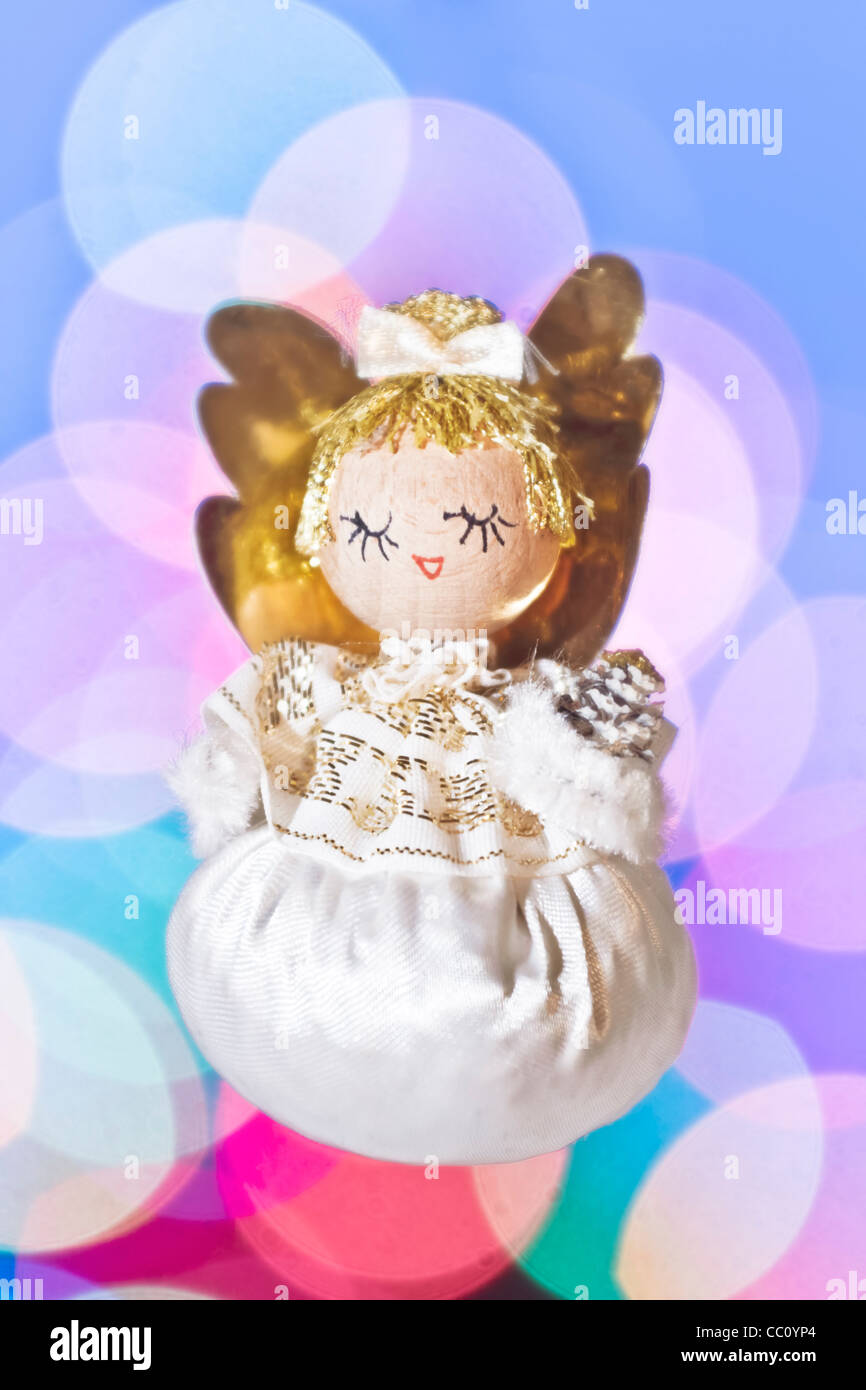 Christmas angel against a background of out-of-focus lights Stock Photo