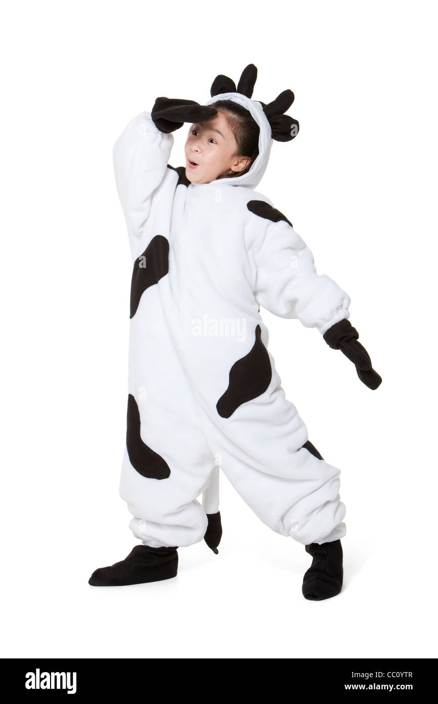 Cute girl in a cow costume playing Stock Photo Alamy