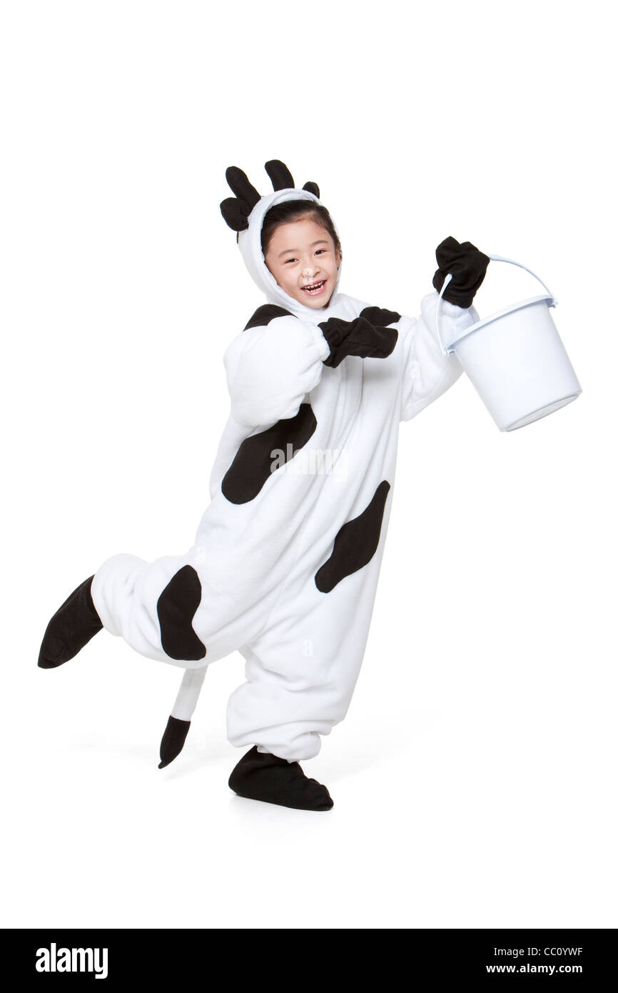 Cute girl in a cow costume with a bucket Stock Photo Alamy