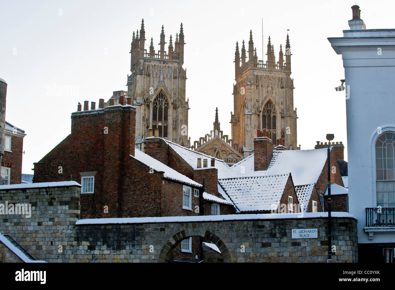 York Minster west towers shot from Exhibition Square, with snow covered roofs in foreground. Stock Photo