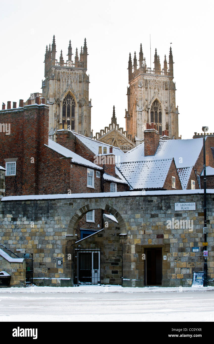 York Minster west towers shot from Exhibition Square, with snow covered roofs in foreground. Stock Photo