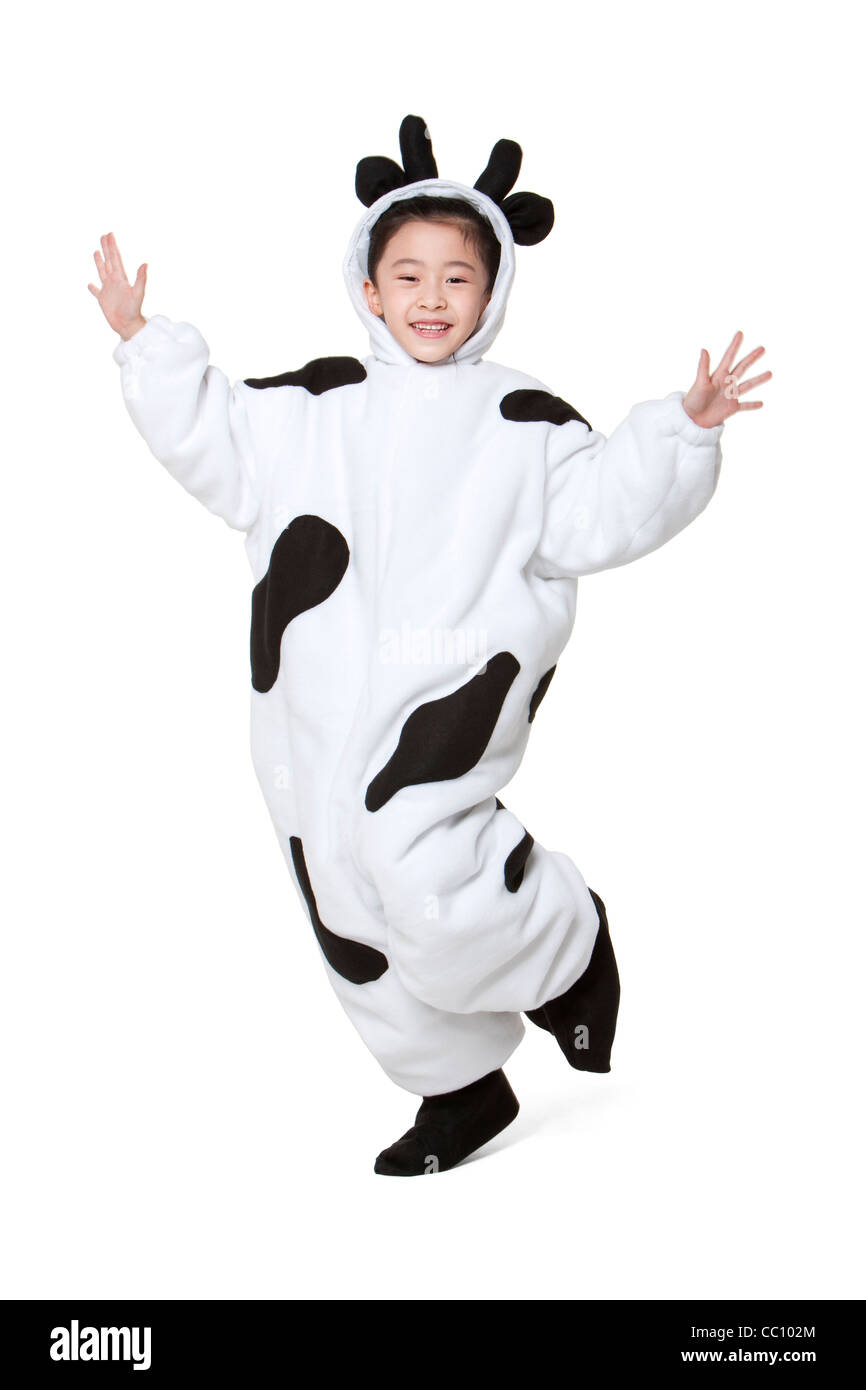 Cute girl in a cow costume playing Stock Photo Alamy