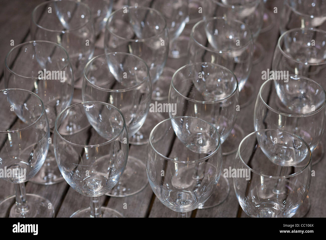 rows of empty wine glasses on a table Stock Photo