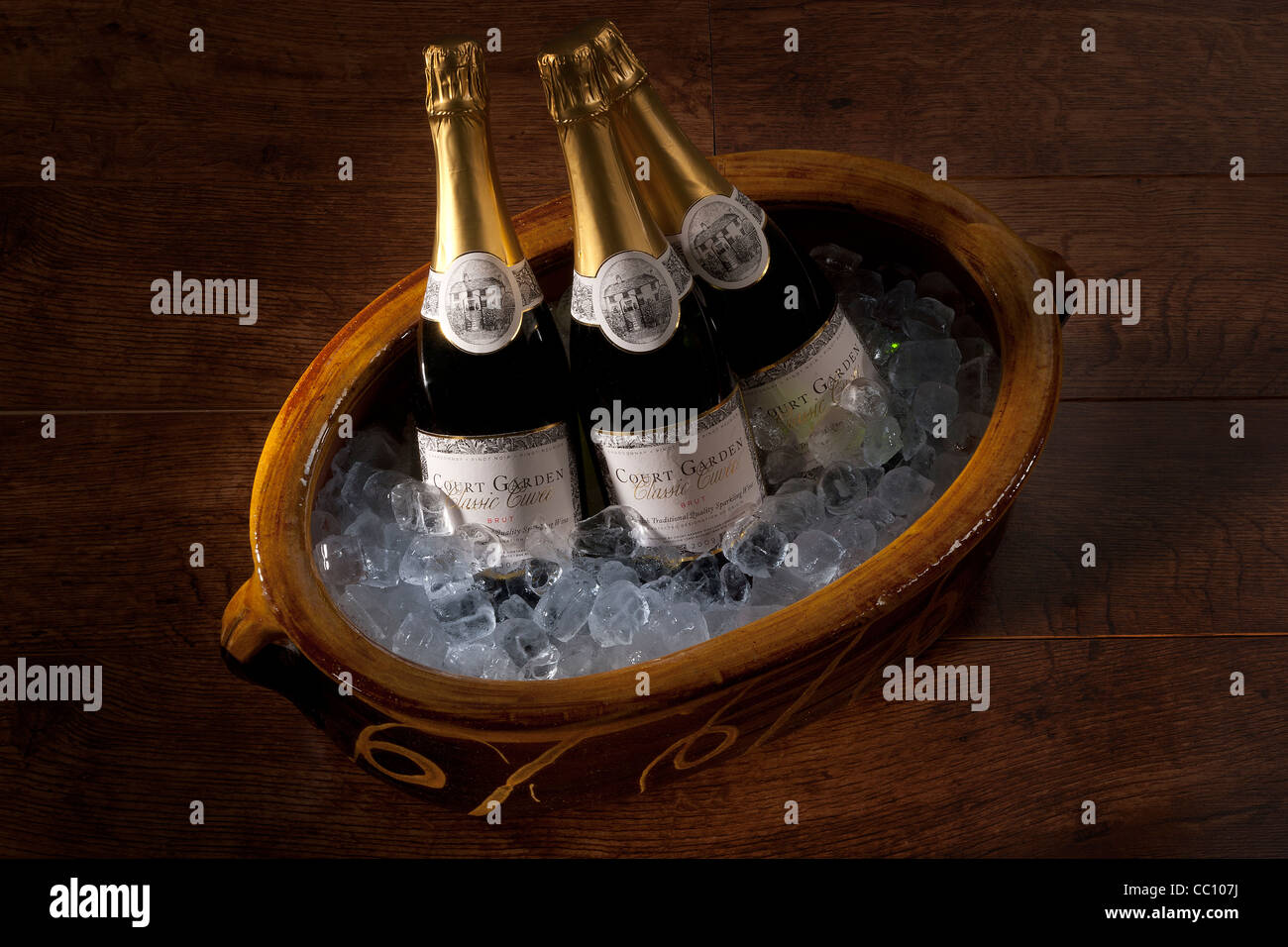 Three bottles of English sparkling wine on ice Stock Photo