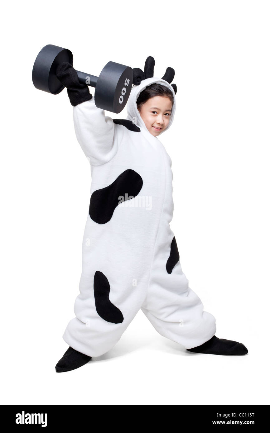 Cute girl in a cow costume lifting a dumbbell Stock Photo Alamy