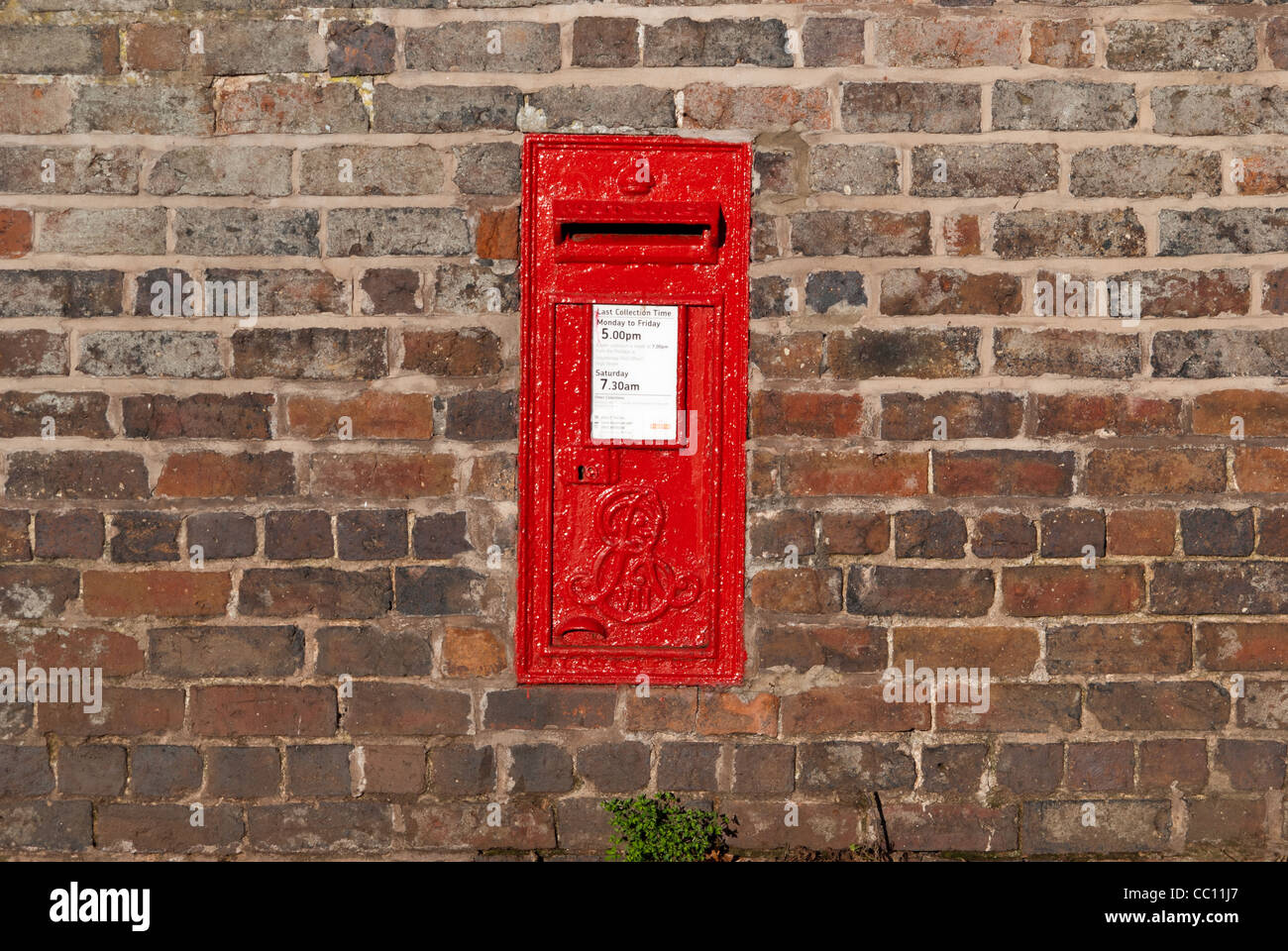 Red post bock inset in brick wall Stock Photo